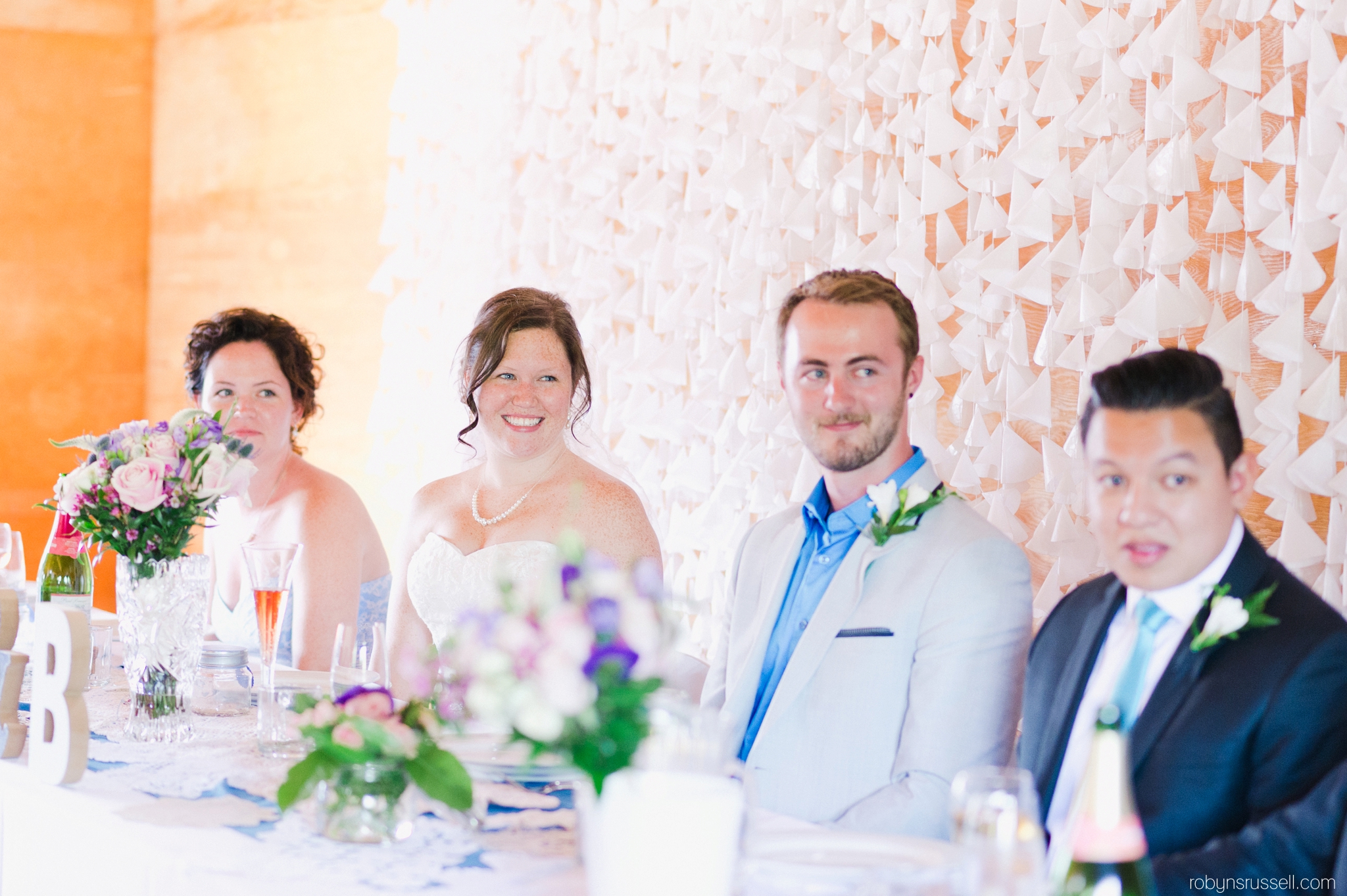 48-bride-and-groom-with-bridal-party-at-dinner.jpg